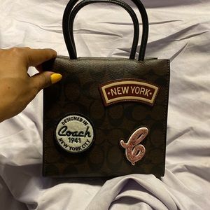 Mini Cally Crossbody In Signature Canvas With Ski Patches. Never worn